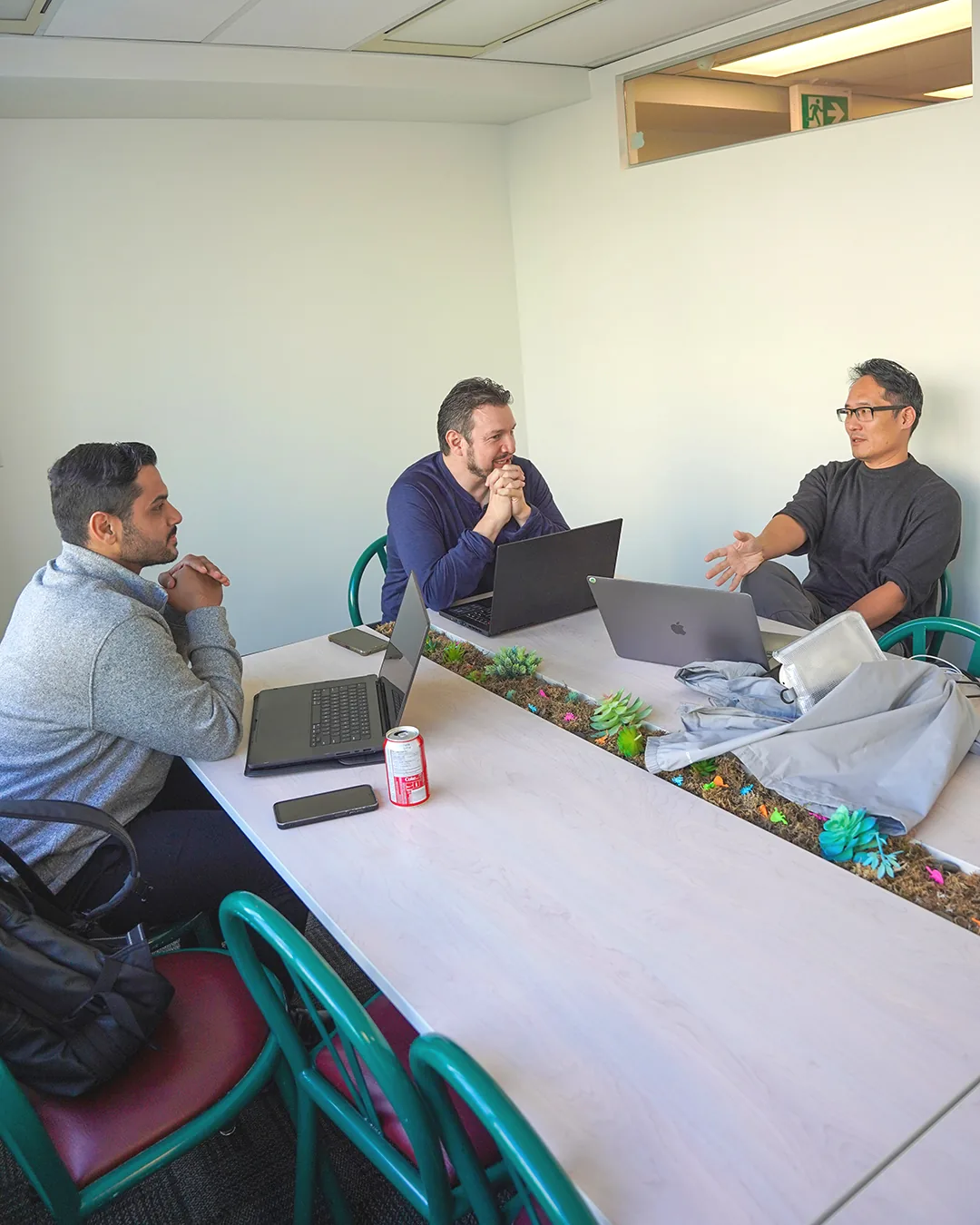 Builders sharing ideas around laptops at Alebex's first Vancouver hackathon