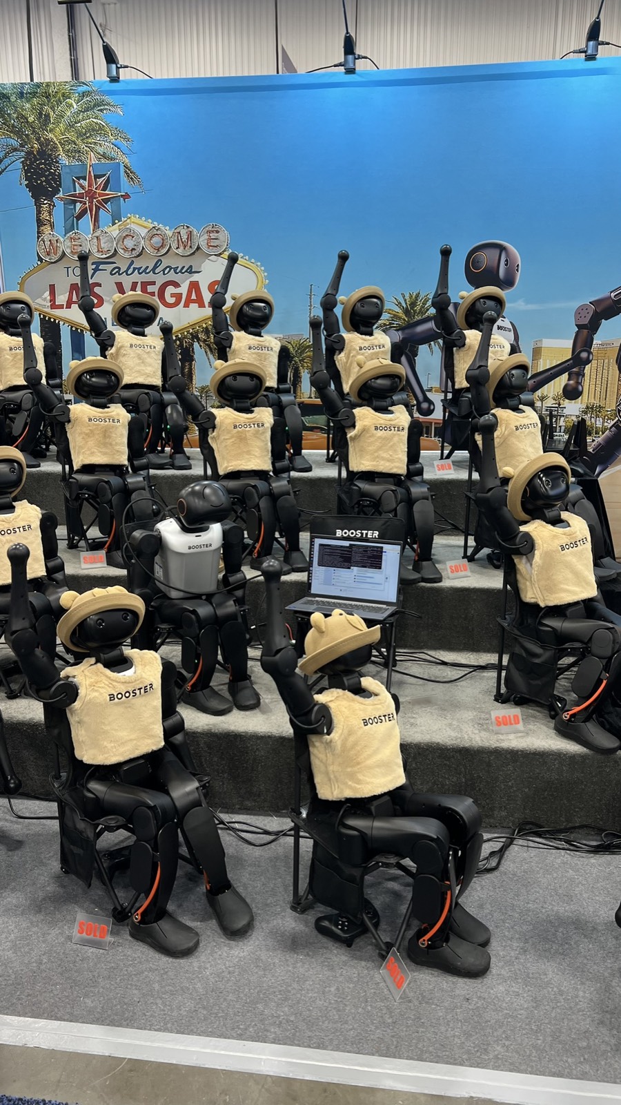 Booster humanoid robots with Vegas sign backdrop